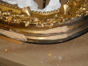 Close-up of a metal picture frame being restored